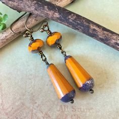 These premium pumpkin orange faceted Czech glass bead dangles will be a great addition to your Fall wardrobe. Each bead has a beautiful aged finish on the top and bottom, creating a vintage look. These lightweight earrings have a 1.5" drop and are 1/4" at the widest. All of the brass tone components are non-tarnish & hypoallergenic to help with any skin sensitivity. Processing time is only 1-2 business days & will be gift wrapped in a cloth boho bag. Notice: One boho drawstring bag per order. If Orange Czech Glass Dangle Earrings, Handmade Orange Drop Jewelry, Handmade Orange Long Drop Earrings, Vintage Orange Czech Glass Earrings, Vintage Orange Dangle Earrings, Vintage Orange Earrings With Czech Glass, Adjustable Orange Teardrop Earrings, Vintage Orange Nickel-free Earrings, Bead Dangles