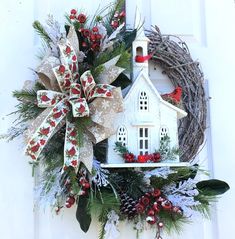 a wreath with a church and holly on it