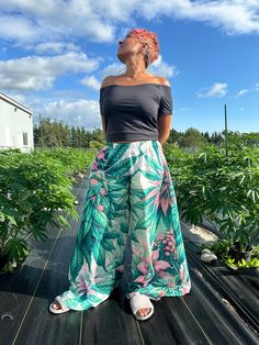 Roll into effortless elegance with the Pink Haze Wide Leg Pants, designed for the stylish and free-spirited Jane Dope woman. Featuring a stunning blooming buds and flowers print, these pants are perfect for adding a touch of floral flair to your wardrobe. Features: Unique Print: Adorned with a vibrant all-over blooming buds and flowers Jane Dope print, these pants bring a burst of color and nature-inspired style to any outfit. Comfortable Fit: Made from a soft and breathable blend of 95% polyest Bohemian Bottoms With Tropical Print For Spring, Bohemian Tropical Print Bottoms For Spring, Tropical Green Cotton Bottoms, Outfit Comfortable, Baby Boy Pants, Casual Summer Wear, Flowers Print, Pantalon Large, Effortless Elegance