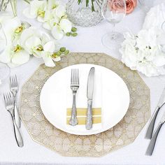 a place setting with flowers and silverware