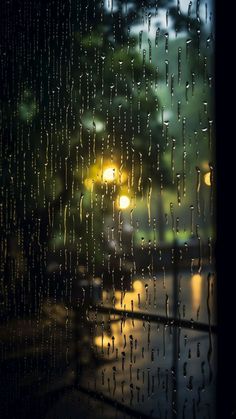 rain is falling down on the window outside