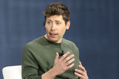 a man sitting in a chair with his hands out