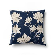 a blue pillow with white flowers on it