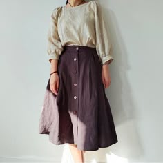 "This Button Front Linen Skirt with Pockets is a beautiful vintage-inspired piece that combines style and functionality. Made from high-quality linen fabric, this A-line skirt features a midi length, which falls just below the knee. The washed finish gives it a relaxed, casual vibe that makes it perfect for everyday wear. The skirt is designed with a button front closure, which adds a touch of elegance and sophistication to the overall look. The buttons are placed asymmetrically, creating an int Sewing Midi Skirt, Skirt With Button Up Shirt, Prairie Skirt Outfit, Plain Skirt Outfit, Style For Women In Their 30s, Historical Skirt, Knee Length Skirt Outfit, Linen Skirt Outfit, Midi Skirt Outfits