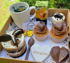 a box filled with lots of cupcakes on top of a table