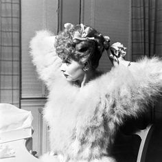 a woman sitting at a table in front of a cake