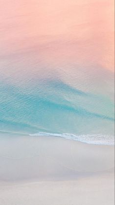 two surfers walking on the beach with their surfboards