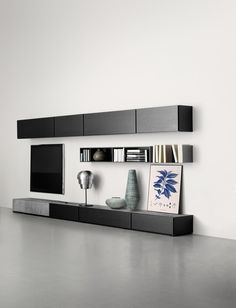 an image of a modern living room with black and white decor on the wall, bookshelf in the background