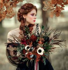 a woman with long hair holding a bouquet in her hands and wearing a black dress