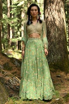 Fern green tiered lehenga with bagh print, moti, dabka work, sequins and zari embroidery. Comes with sleeveless blouse, scallop dupatta and cutdana belt.
Component: 4
Pattern: Print and Embroidery
Type Of Work: Bagh Print,  Moti, Dabka Work, Sequins, Cutdana and Zari
Neckline: V neck
Sleeve Type: Sleeveless
Fabric: Lehenga: Georgette, Blouse: Crepe and Dupatta: Tissue 
Color: Green
Other Details: 
Embroidered dupatta with scallop border
Back with tie and tassels
Padded blouse
Occasion: Sangeet - Scallop Dupatta, Paulmi And Harsh, Tiered Lehenga, Bagh Print, Dabka Work, Print Lehenga, Scallop Border, Zari Embroidery, Green Lehenga