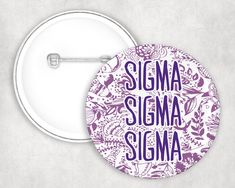 a purple and white button with the words stigmaa sigma in floral designs