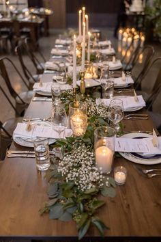 a long table is set with candles and place settings