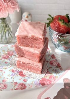 three pieces of pink cake sitting on top of a table