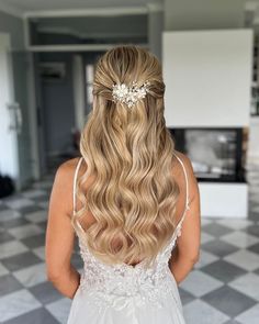 the back of a woman's head with long blonde hair