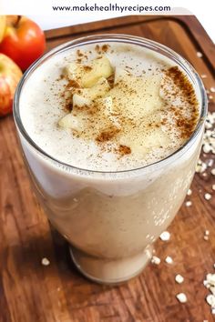 an apple cider is garnished with cinnamon and flakes on a cutting board