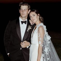 a man and woman in formal wear posing for the camera at their wedding night time