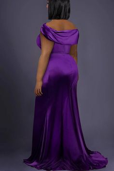 the back of a woman in a purple gown with an open shoulder and draped over her shoulders