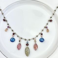 Elegant drape necklace featuring Marquee Gems as accents on Pyrite rosary style chain with draping marquee Labradorite and Marsala Qz, heart shape Spinel Qz and teardrop Dk Tea Qz. Length: 18-20″ (can request up to 24″ as well, no extra charge) Best Selling Necklace! Gems Necklace, Elegant Drapes, Gem Necklace, Rosary, Heart Shape, Labradorite, Heart Shapes, Beaded Necklace, Gems