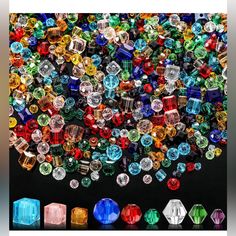 there are many different colored stones on the black surface, and one is surrounded by smaller ones