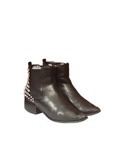 "Give your ensemble an unforgettable look with the Ashley Chelsea boot from Steve Madden. This edgy pair is fashioned with leather and stud accents along the heel counter. Boots are Equipped with a classic pointy-toe, pull tab, elastic gore for extra leg room amd a more comfortable fit. Air them wothbyour favorite jeans or leggings!  **Some wear and tear on the heels of both boots with a slight peel on the sole of the right but overall in good condition!  Length: 10 1/2\" Width: 3 5/6\" Height: 4 1/2\" Heel: 1 5/8\" Top/Calves: 10\" Color: Black  Condition: Good Vintage  Brand: Steve Madden" Trendy Leather Martin Boots For Party, Edgy Ankle Boots In Faux Leather, Edgy Ankle Martin Boots For Spring, Edgy Faux Leather Ankle Boots, Trendy Pointed Toe Moto Boots For Fall, Ankle-high Boots With Rivets For Fall, Trendy High Ankle Boots With Rivets, Punk Style Leather Heeled Boots For Fall, Edgy Ankle-high Platform Boots For Fall