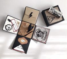 an assortment of harry potter themed items are on display in small boxes with tags and magnets