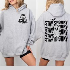 Stay Spooky Sweatshirt, Halloween Sweatshirt, Halloween Gifts Hoodie, Womens Halloween Sweatshirt, Spooky Season Sweatshirt, Ghost Halloween Hello! Welcome to Cstm Tshrt Designs, Discover our premium personalized t-shirts crafted from luxurious materials that provide a delightful feel against your skin. Choose from a diverse array of colors and designs to find a shirt that perfectly aligns with your unique personality and style preferences. Whether you seek a humorous graphic tee, a bold stateme Trendy Graphic Print Halloween Hoodie, Spooky Long Sleeve T-shirt For Winter, Spooky Long Sleeve Halloween Hoodie, Hooded Spooky Halloween Sweatshirt, Spooky Hooded Halloween Sweatshirt, Halloween Hooded Spooky Sweatshirt, Trendy Oversized Hoodie For Halloween, Hooded Graphic Print T-shirt For Fall, Funny Long Sleeve Hoodie With Graphic Print