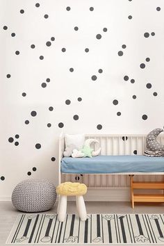 a child's room with black and white polka dots on the wall