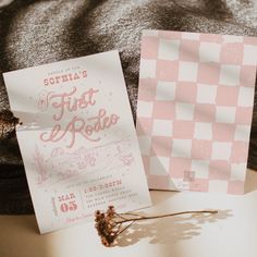 two pink and white flyers sitting on top of a bed