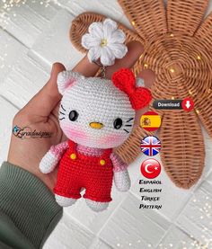 a crocheted hello kitty keychain with a flower in it's hair