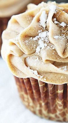 a cupcake with icing and powdered sugar on top