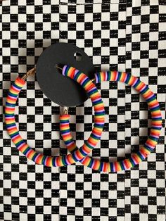 multicolored bracelets on black and white checkered background