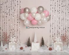 balloons and decorations are displayed on the mantle for a winter themed birthday party with snowflakes