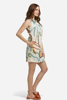 Elevate your summer wardrobe with our Camilla Abstract Print Linen Mini Dress! Made with lightweight linen, it features a high neckline, sleeveless silhouette, and convenient side-seam pockets. Pair it with our Zoe Orange Bow sandals for a casual day look or dress it up with heels for a chic night-time ensemble. Embrace the warm weather in style and comfort with this versatile piece. Made in Italy by BravaaComposition:100% LinenFit:Model 1 is wearing a size Small. Model's measurements: Height 5' Casual Unlined Linen Dress For Spring, Summer High Neck Beige Dress, Unlined Linen Dress For Day Out, Beige High Neck Summer Dress, Beige High Neck Dress For Summer, High Neck Beige Dress For Summer, Fitted Casual Linen Dress Unlined, Unlined Knee-length Linen Dress, Chic Beige Linen Sleeveless Dress