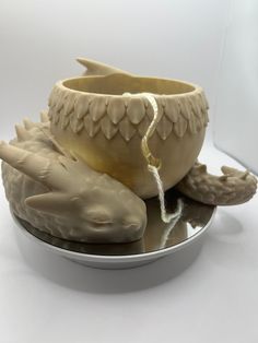 there is a bowl with two dolphins in it on the plate and one has a rope