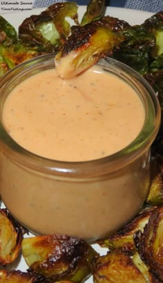 a plate topped with brussel sprouts and dipping sauce