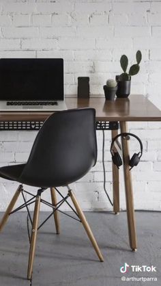 a desk with a laptop and headphones on it