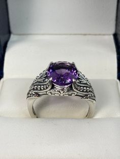 "Natural Purple Amethyst Ring Small Oval Gothic Design#85 Custom made This is a brand new stunning Gothic/Renaissance inspired sterling silver filigree ring. The flawless oval-cut high-quality natural purple amethyst is 11mm (7/16th of an inch) by 9mm (just shy of 3/8\" inch) in dimension... The inside of the band is marked 925 for sterling. Notice the beautiful filigree swirl like the craftsmanship of the silver setting. This is an exquisite rendition of a Gothic design filigree ring.... and is Classic Amethyst Rings With Gemstone Accents, Oval Hallmarked Amethyst Ring In White Gold, Classic Oval Amethyst Ring With Accent Stones, White Gold Amethyst Ring With Gemstone Accents, Oval Amethyst Ring In White Gold With Accent Stones, Formal Purple Round Topaz Ring, Classic Purple Amethyst Ring With Vs Clarity, Amethyst Gemstone With Center Stone, Oval Amethyst Ring With Vs Clarity For Wedding