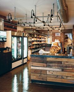 the inside of a store with lots of items on display and wood pallets in front of it