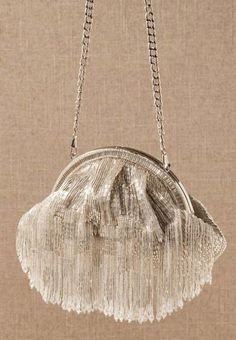 Opt for an effervescent pouch to tote your wedding day necessities with this flamboyant design adorned with a shower of pearlescent tassels. crystals, brocade lining magnetic snap-clasp closure 9"L x 3"W x 7"H 16" strap Gatsby Glam, Wedding Accessories For Bride, Bridal Clutch Bag, Faux Fur Wrap, Bridal Clutch, Tassel Bag, Beaded Bags, Beaded Tassels, Lariat Necklace