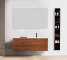 a bathroom with a wooden cabinet, mirror and shelving unit on the wall next to it