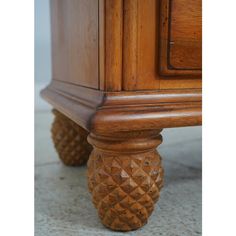 an antique pineapple style dresser with drawers and knobs