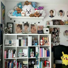 a room filled with lots of books and stuffed animals on top of the bookcases