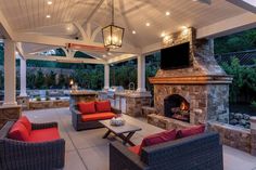 an outdoor living area with fireplace and seating