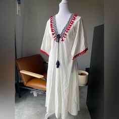 Cute Linen Material Dress With Tassels, Pom Poms On The Sleeves, And Embroidery. Never Worn. Cotton Vacation Dresses With Back Tassel Tie-up, Folk Style V-neck Dress For Vacation, White Maxi Dress With Tassels, White Fringe V-neck Dress, White V-neck Dress With Fringe, White Embroidered Zara Dress, Short Sleeve Dress With Tassels For Vacation, Traditional Vacation Maxi Dress With Tassels, Traditional Tunic Dress With Tassels