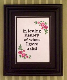 a cross stitch picture with the words in loving memory, and flowers on it's border