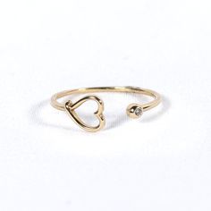 Experience unique charm with our Claw Ring with Heart. Crafted in 10K solid gold, this captivating ring features a delicate heart nestled within an intricately designed claw, adding a touch of edgy elegance and romance to your look. 10K Yellow Gold White Zirconia Tarnish Resistant Open Heart Promise Ring, 14k Gold Heart Ring With Birthstone For Promise, Tarnish-resistant Open Heart Promise Ring, 14k Gold Tarnish Resistant Heart Ring For Promise, Adjustable Heart Charm Ring For Promise, Adjustable Heart Charm Promise Ring, 14k Gold Tarnish Resistant Heart Ring, Adjustable Heart-shaped Yellow Gold Midi Rings, 14k Gold Heart Ring Tarnish Resistant