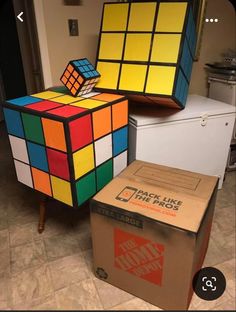 two rubik cubes sitting on top of boxes in the middle of a room