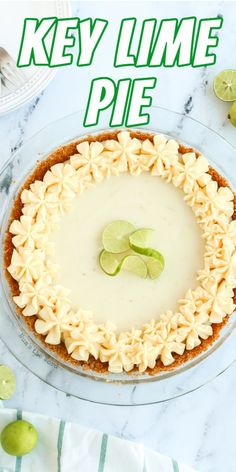 key lime pie on a glass plate with limes around the edges and text overlay