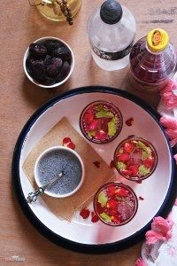 three desserts on a plate with flowers around them