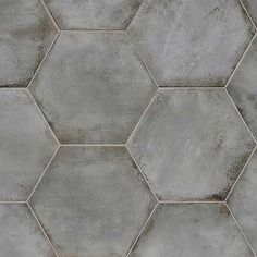 a cement hexagonal tile pattern that looks like it has been painted in grey